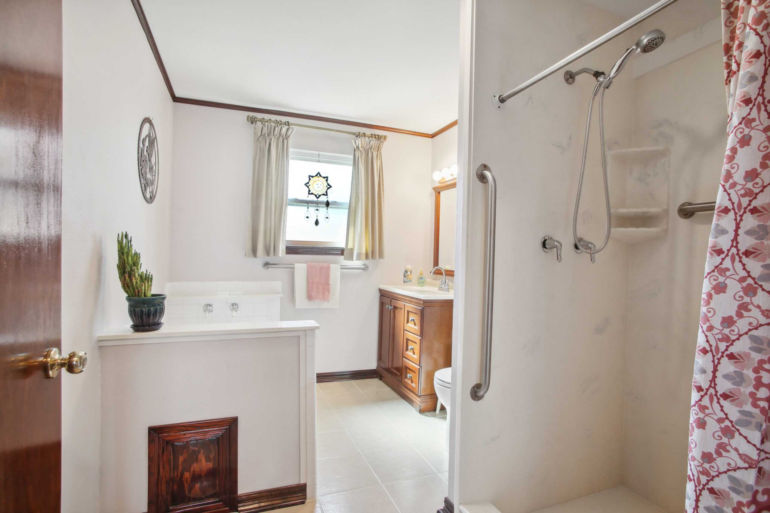 This modest Bathroom with safety features in the separate shower lives large!