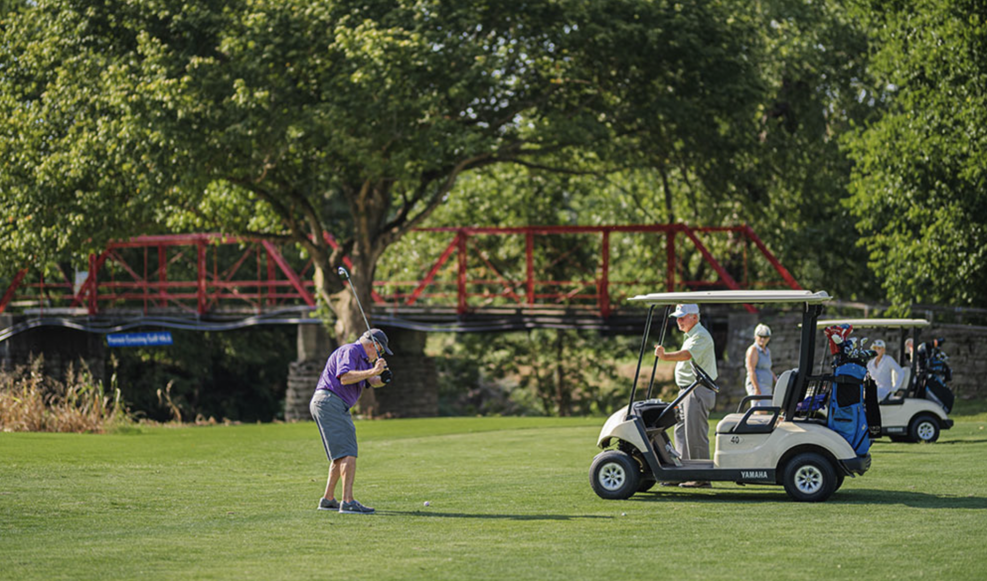 Golfers at Bridge Golf Course in Franklin 3 Golfers on the greenway at Bridge Golf Course in Franklin, with old iron bridge in the background