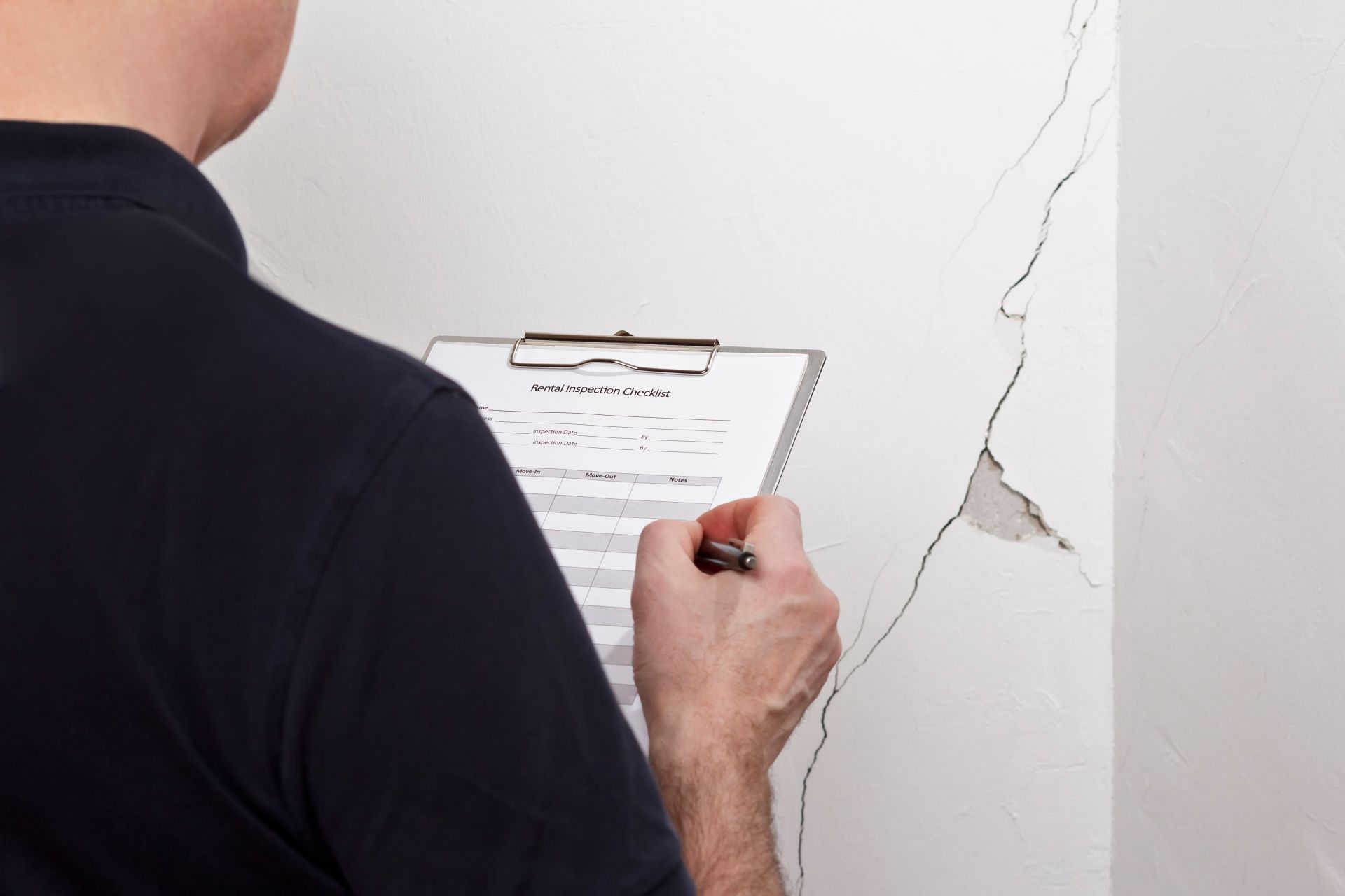 man inspecting the house