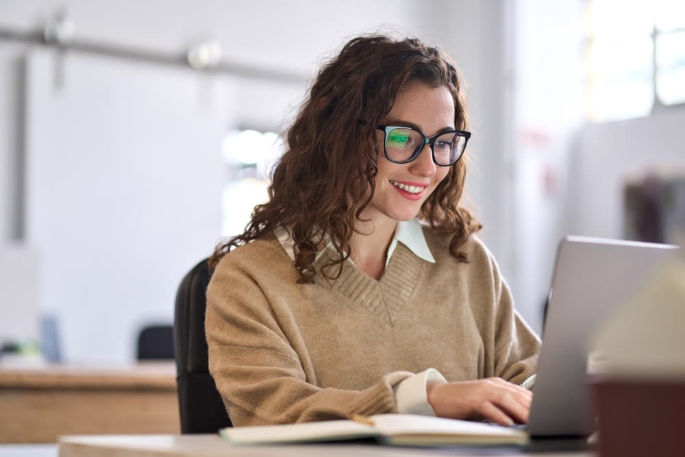 woman-happily-looking-at-finances woman happily looking at finances