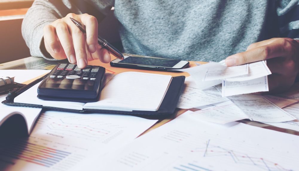 man with calculator and money
