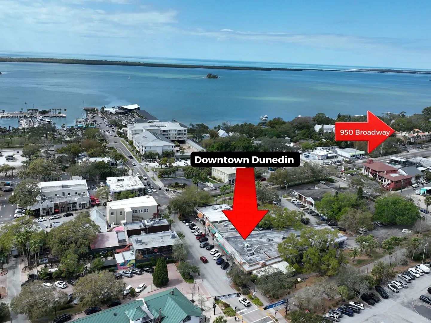 Drone aerial of Downtown Dunedin, Florida showing St. Joseph Sound and the location of the condo at 950 Broadway near the Dunedin waterfront.