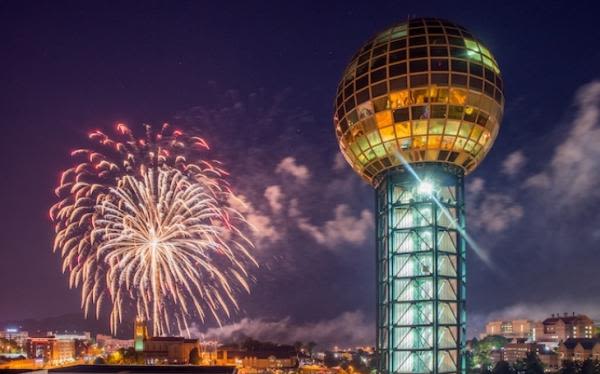 Knoxvilles Sunsphere at night, with fireworks in the background