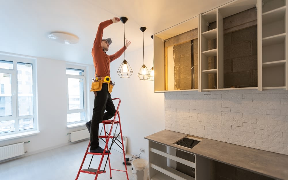 man-fixing-renovating-modern-kitchen man fixing renovating modern kitchen