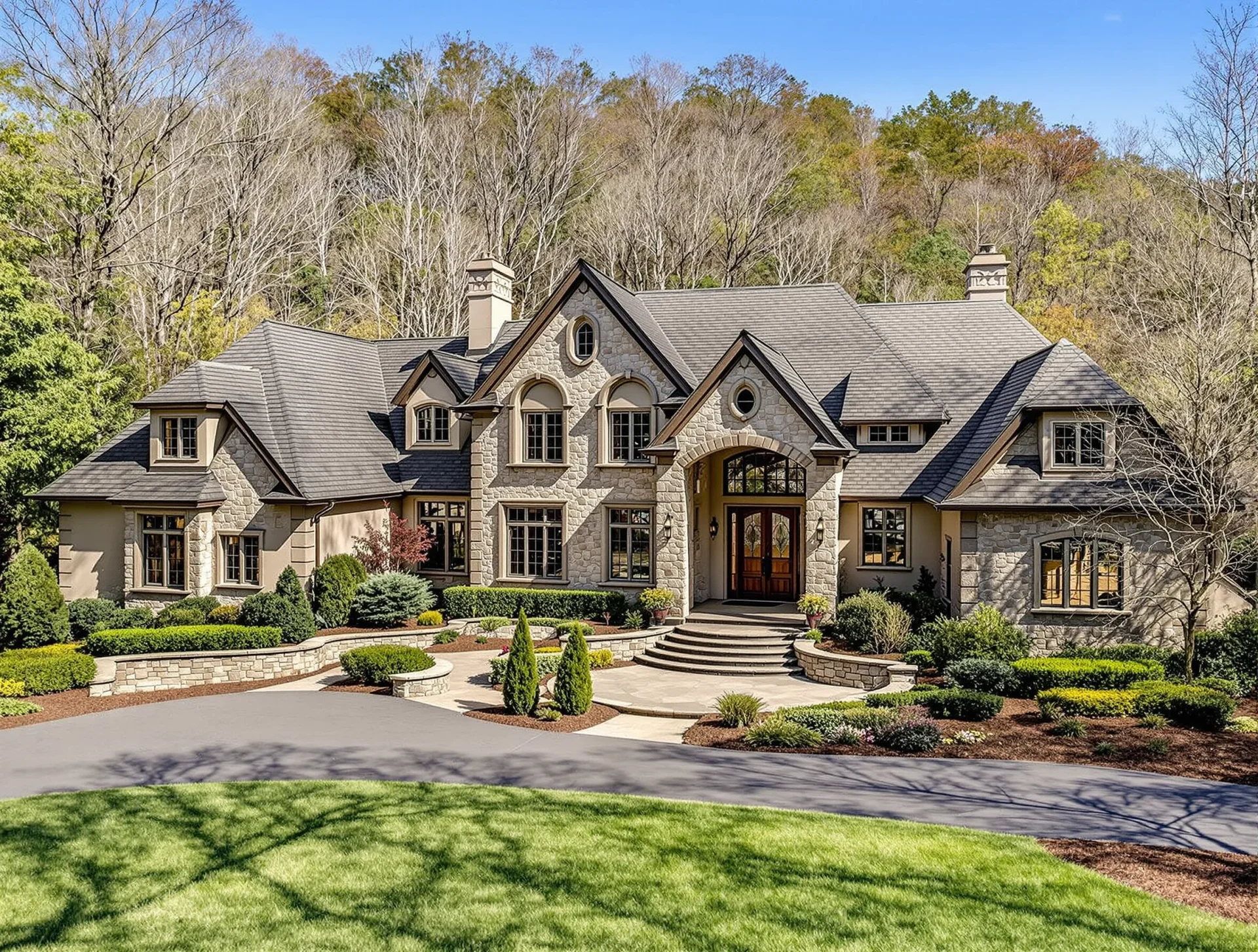Elegant home in Biltmore Forest with manicured yard and wooded backdrop