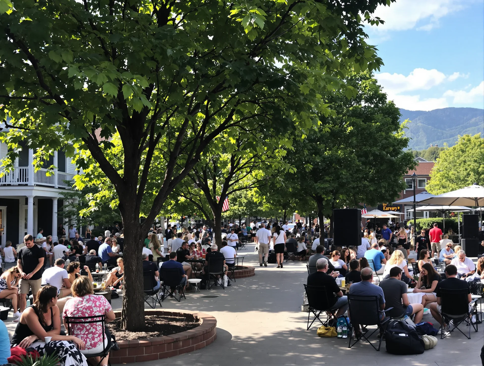 Community gathering in a tree-lined plaza with mountain views in Asheville, North Carolina, USA