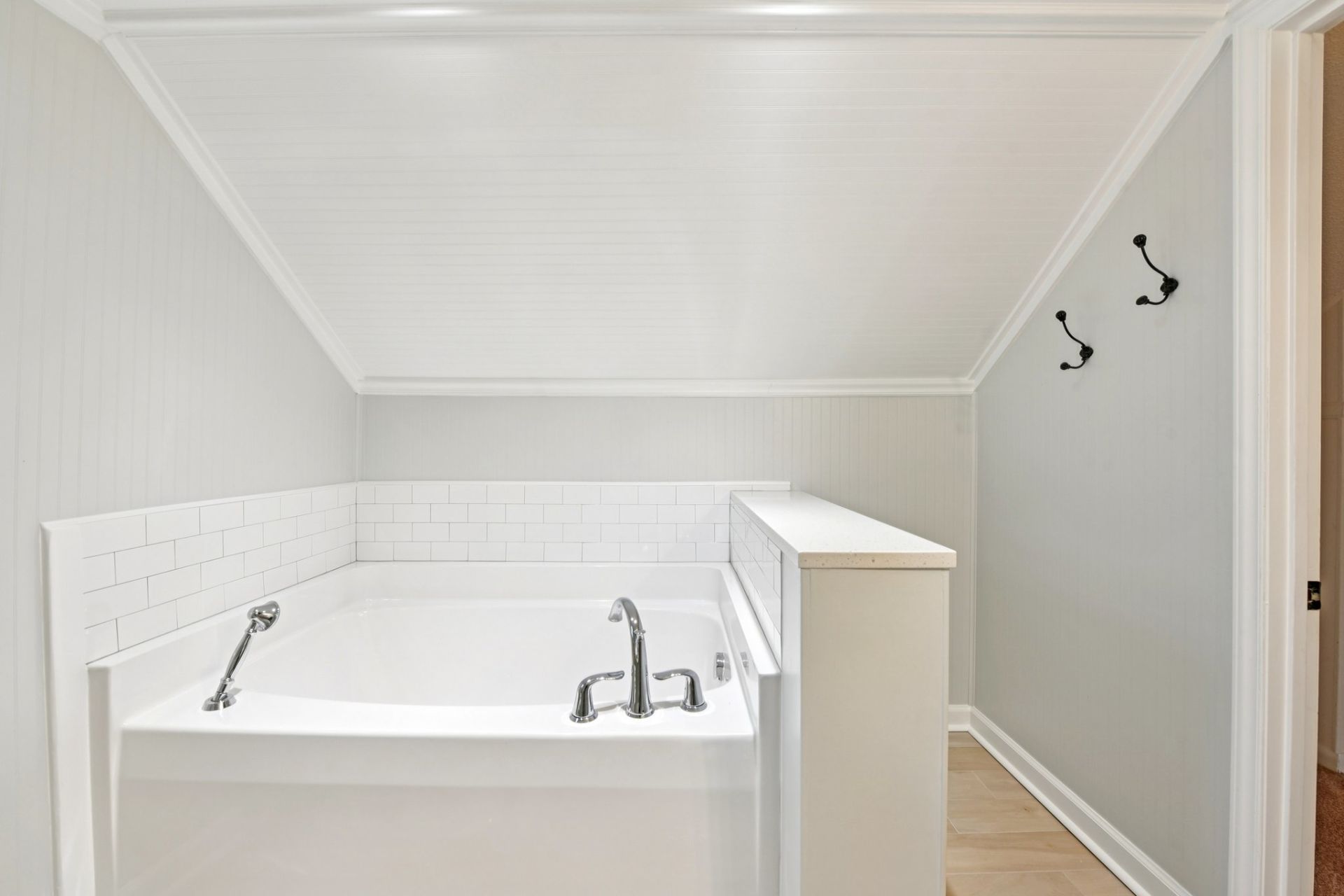 Renovated primary bathroom with tile shower and soaking tub in Concord NC historic bungalow.