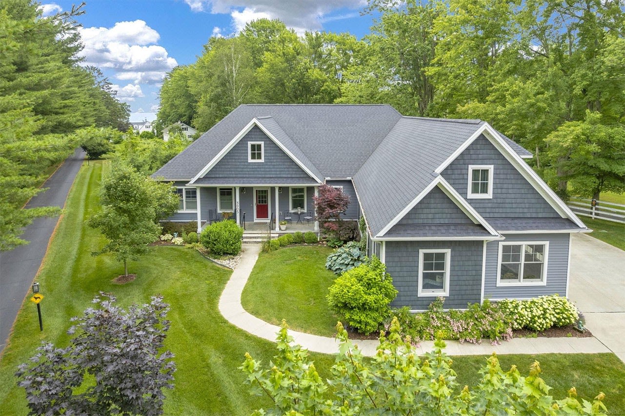 Blue Suburban House with Front Porch and Well-Maintained Lawn, Lexington, MI Real Estate