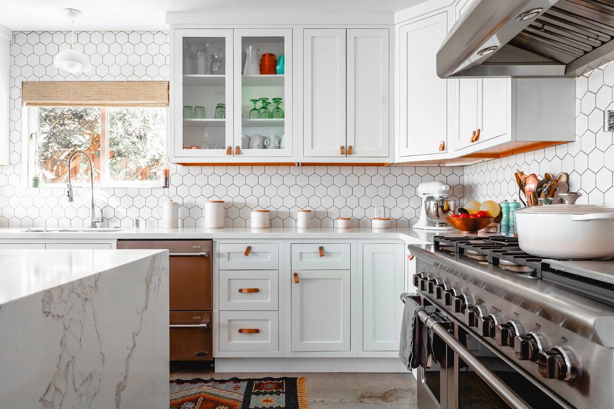 updated kitchen with white cabinets and stainless steal appliances