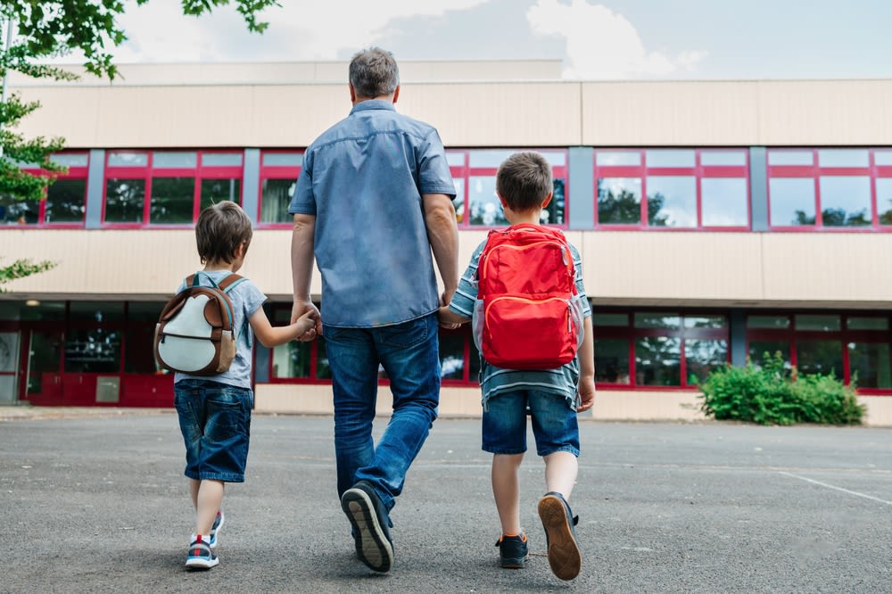 father-taking-kids-too-school father taking kids to school