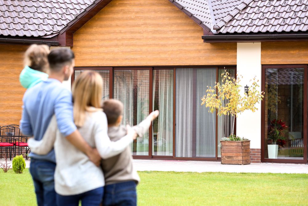 family-looking-at-their-new-house family looking at their new house