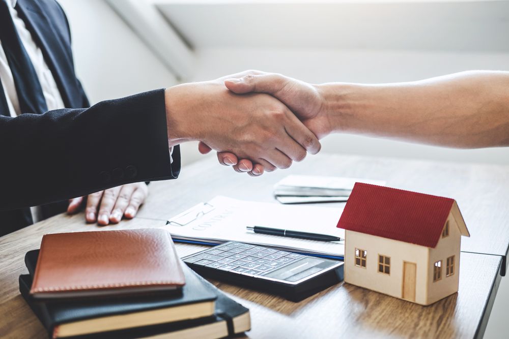 Shaking hands - approve deal - documents Shaking hands approve deal documents