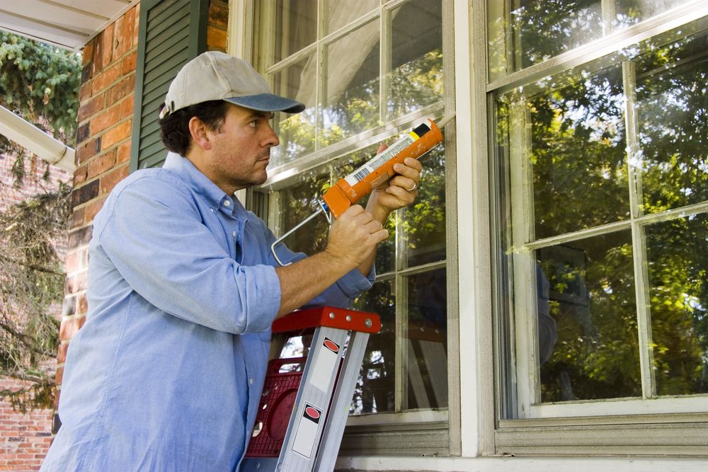 man weatherproofing window