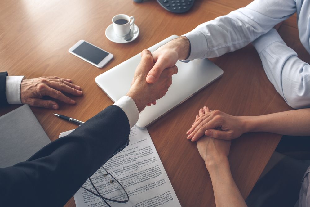 realtor and home buyer shaking hands
