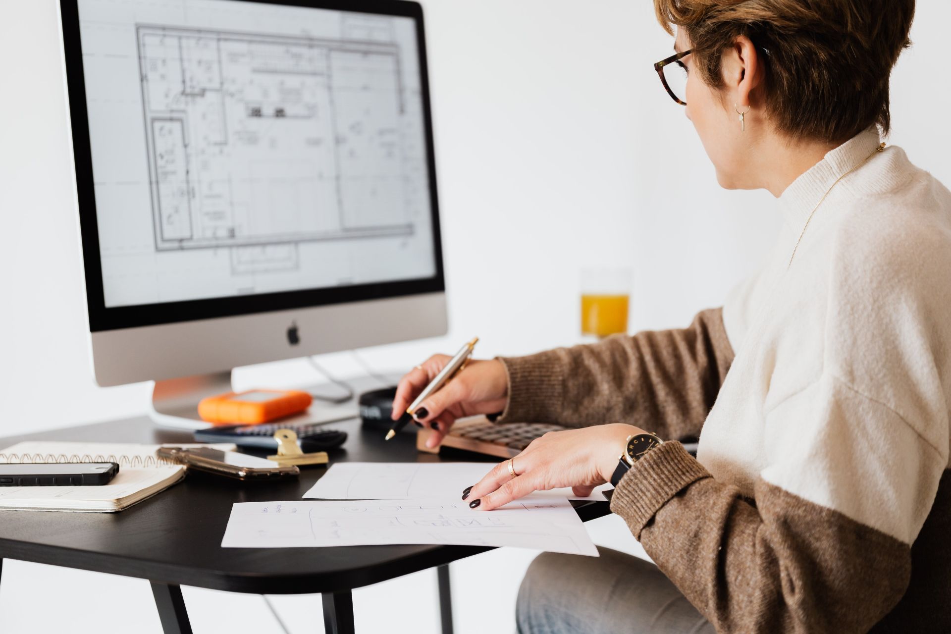 Person-Studying-A-Floor-Plan Person Studying A Floor Plan