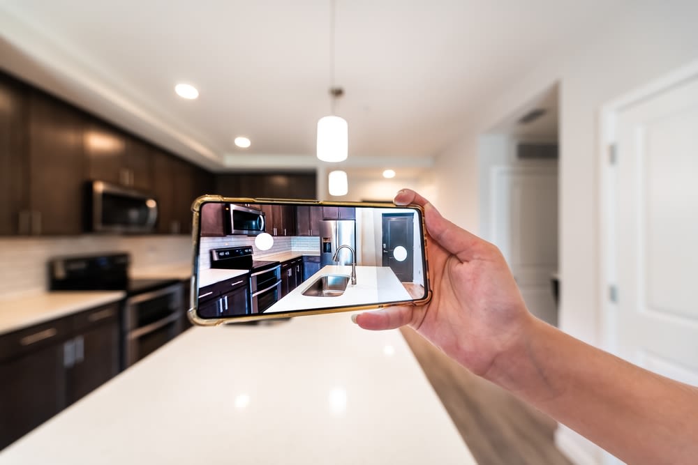 taking-a-photo-of-a-fine-kitchen-using-mobile taking a photo of a fine kitchen using mobile
