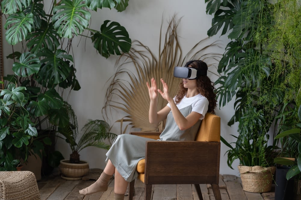 a-woman-sitting-and-using-VR a woman sitting and using VR