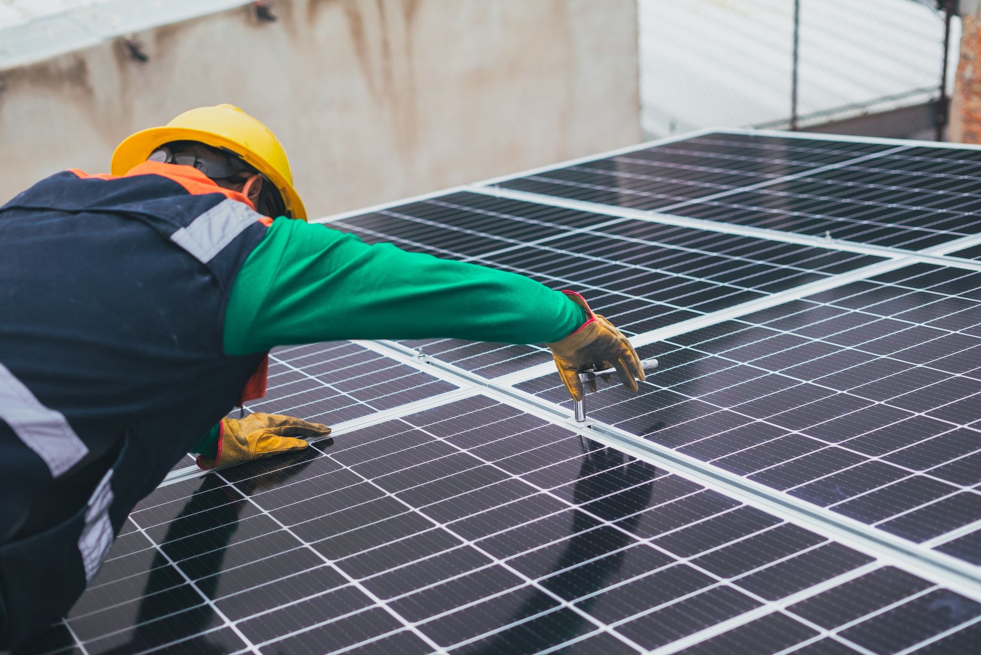 Man-Installing-Solar-Panels Man Installing Solar Panels