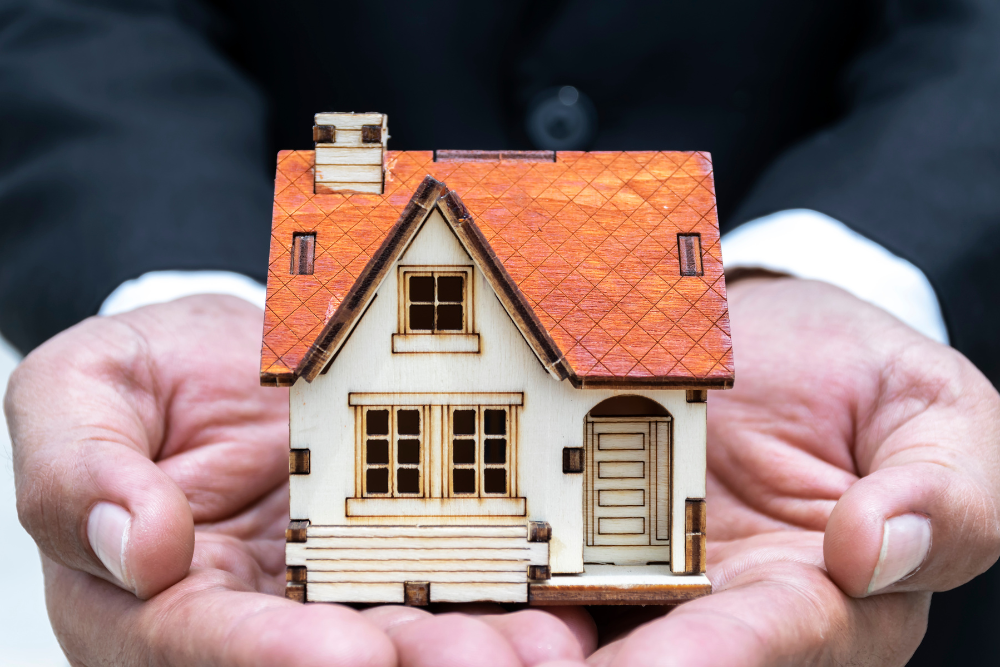 man-holding-a-model-home man holding a model home