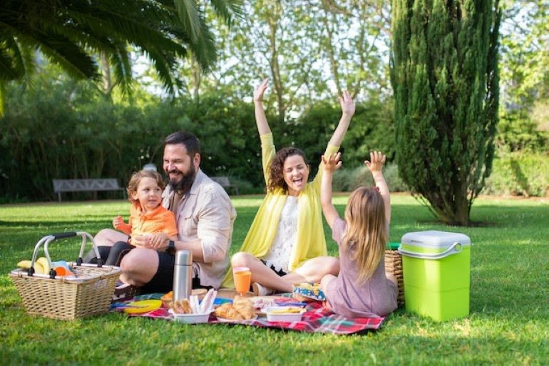 Enjoy nature together A four-member family is having fun at the picnic