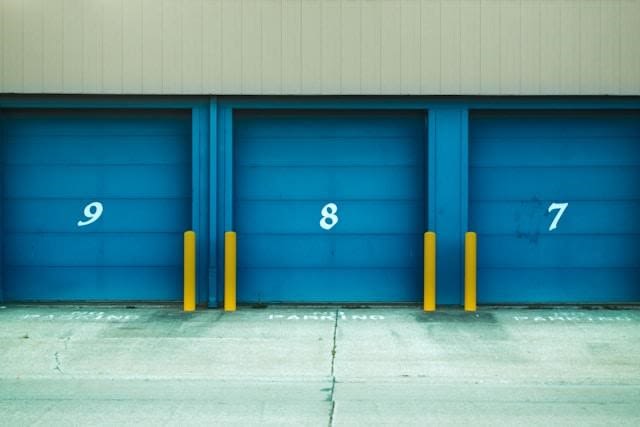 Three blue, numbered storage unit doors.