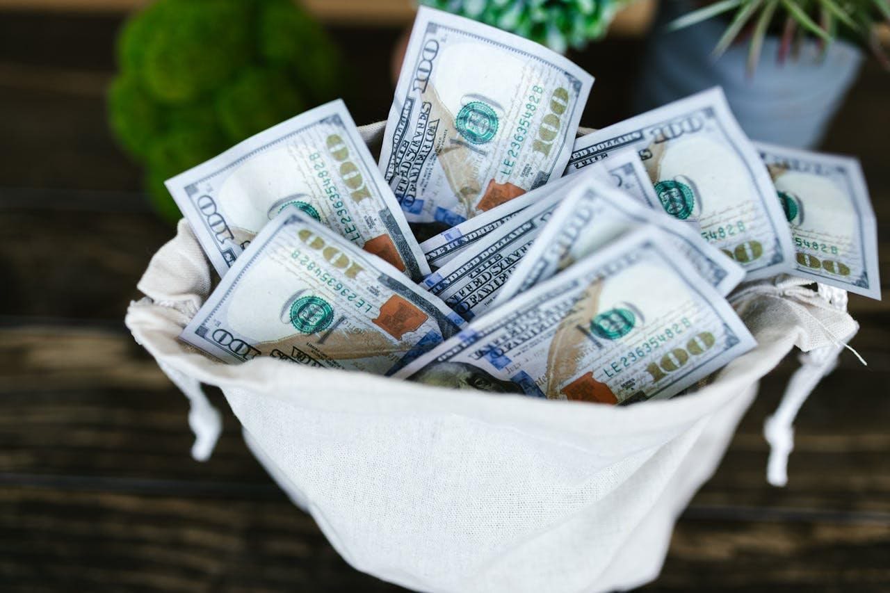 A large earnest money deposit can help in a competitive housing market Close-up photo of dollar bills