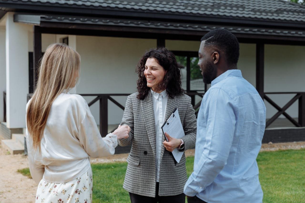 Make your home market-ready and be the first to sell! couple meeting a real estate agent