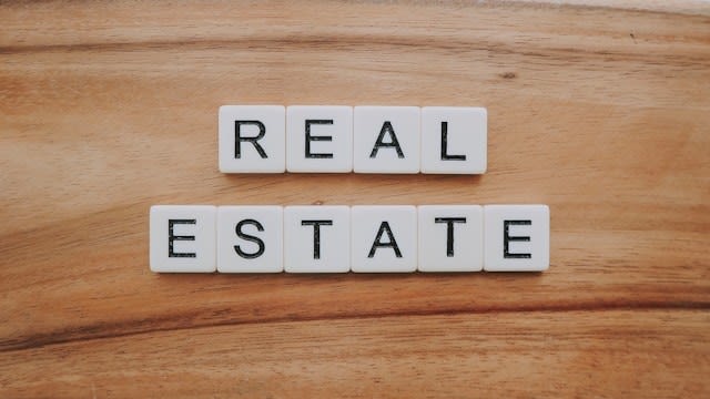White tiles with letters forming ‘real estate’