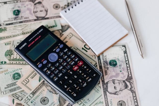 calculator and dollars on the table