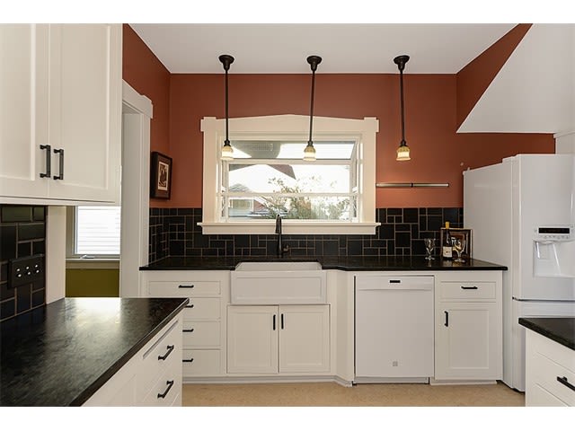 Beautifully Remodeled Kitchen with a Farmhouse Sink and Soapstone Countertops