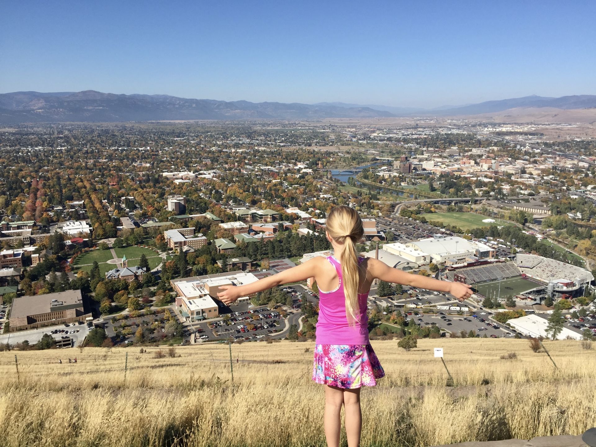 Missoula valley view from Mount Sentinel M trail with young girl overlooking University of Montana campus Beckie Peterson raising her family in Western Montana and serving local buyers and sellers