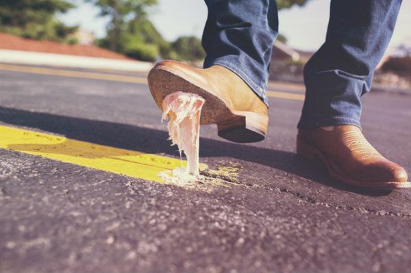 Man stepping in gun in the middle of the road