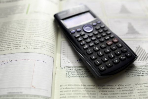 Calculator laying on top of a book
