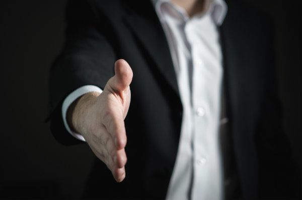 Man holding his hand out for a hand shake
