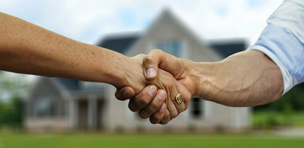 Real estate agent and seller shaking hand