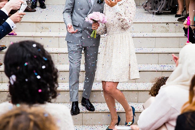 Two people walking down chapel stairs after getting married