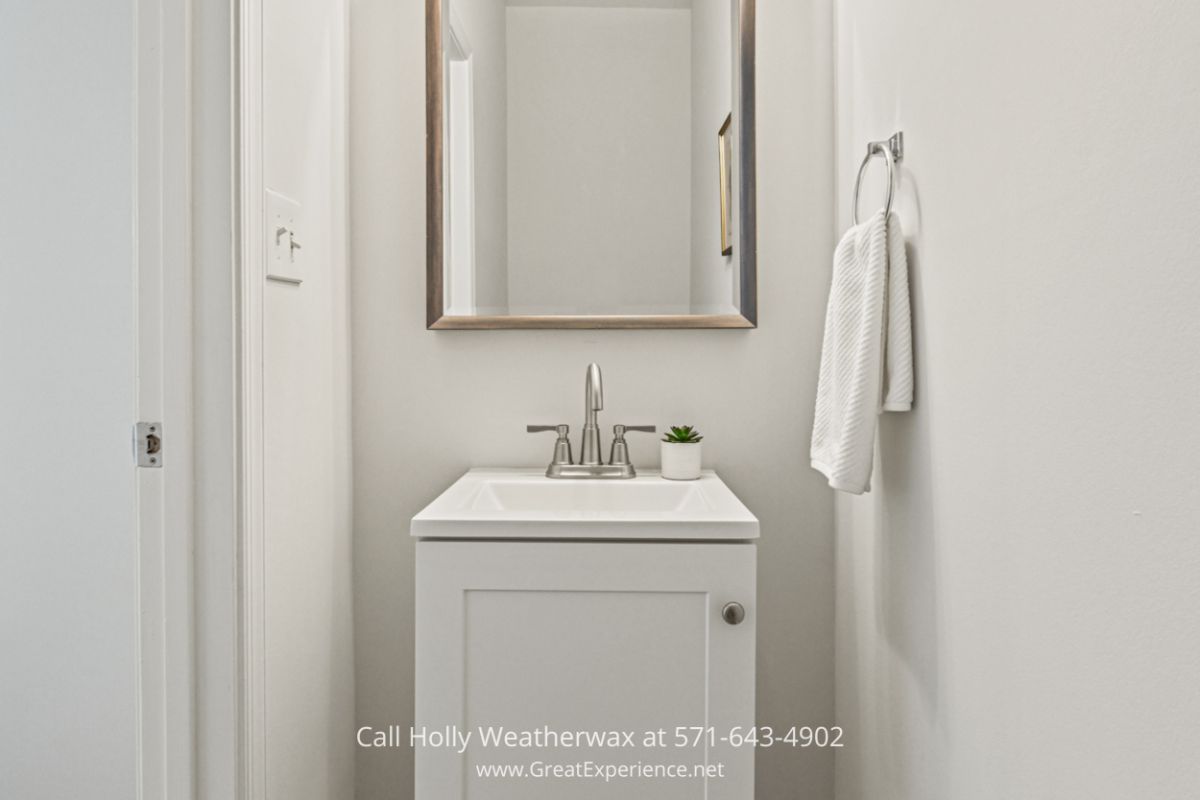 Homes in North Reston VA - The hall powder room of this Reston VA condo is designed with your guest’s convenience in mind. Welcome your guests in style with the beautifully designed hall powder room of this Reston VA condo for sale.