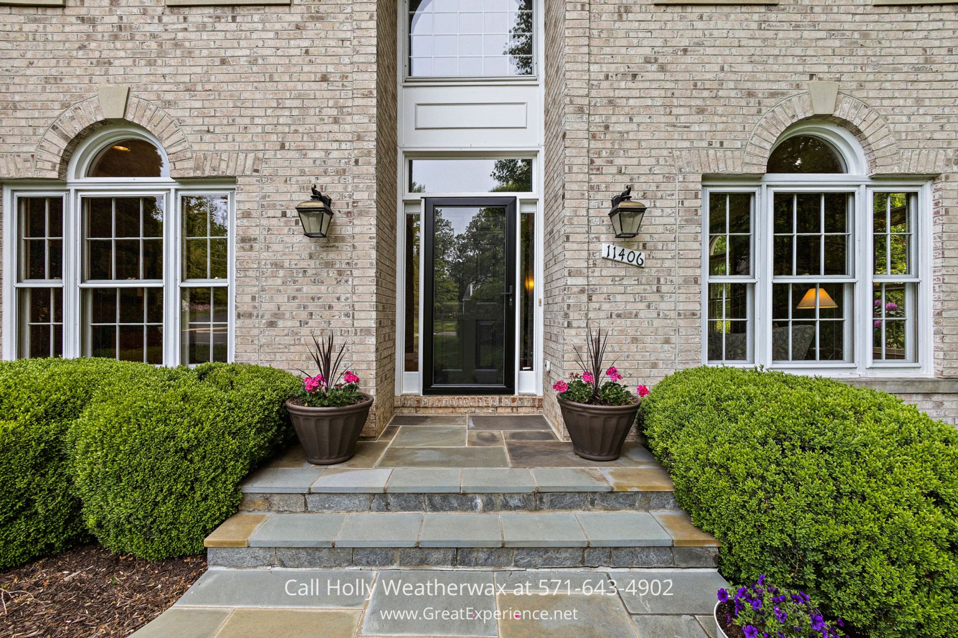 Reston VA Home for Sale - This Van Metre Windsor model home in Northern VA is located in a cul-de-sac. Charming brick house with a striking black door and decorative planters