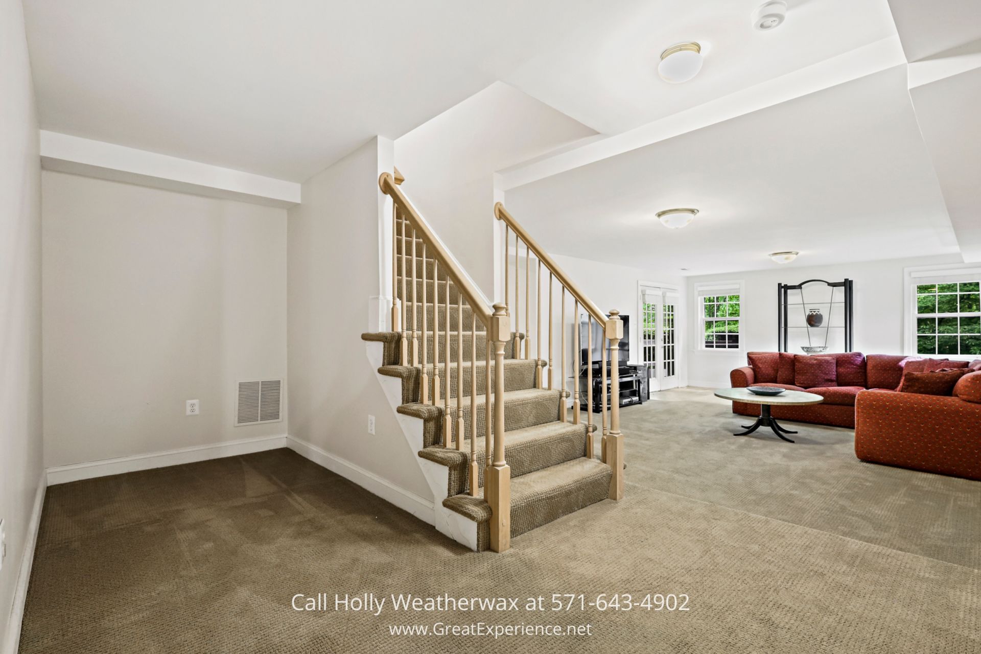 Northern VA Home - Spacious room with an elegant staircase, perfect for family gatherings. Spacious family room with abundant furniture and an elegant staircase