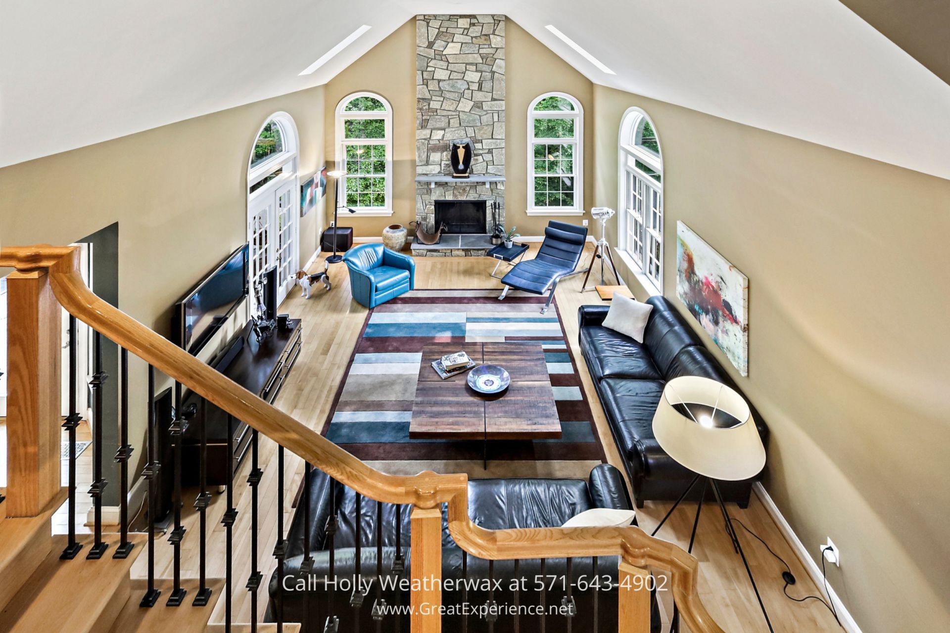 Northern VA Home for Sale - This two-story family room of this Reston VA home is the perfect spot for intimate gatherings. Cozy family room adorned with furniture and a warm fireplace