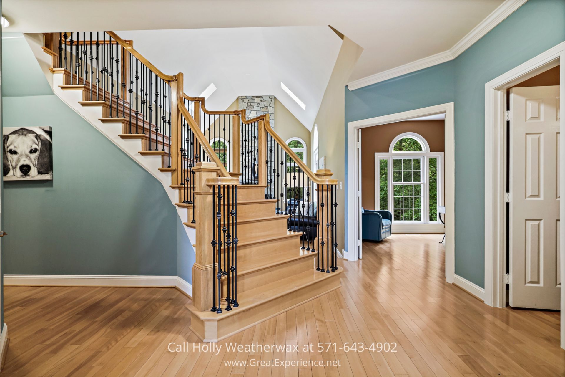 Homes for Sale in Northern Virginia - You will rarely find a central staircase as sophisticated as this one in a home in Reston VA. Elegant staircase in a house with striking blue walls and beautiful hardwood floors