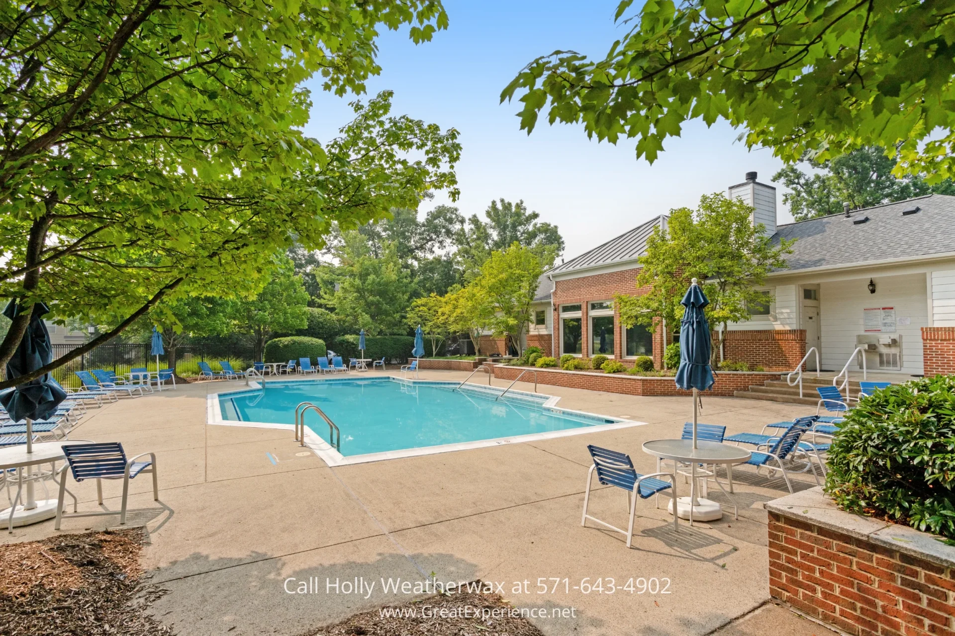 Reston VA Homes for Sale - Have a refreshing soak in the community pool just down the street from this Reston VA home. A refreshing swimming pool surrounded by lawn chairs, umbrellas, and trees in the background