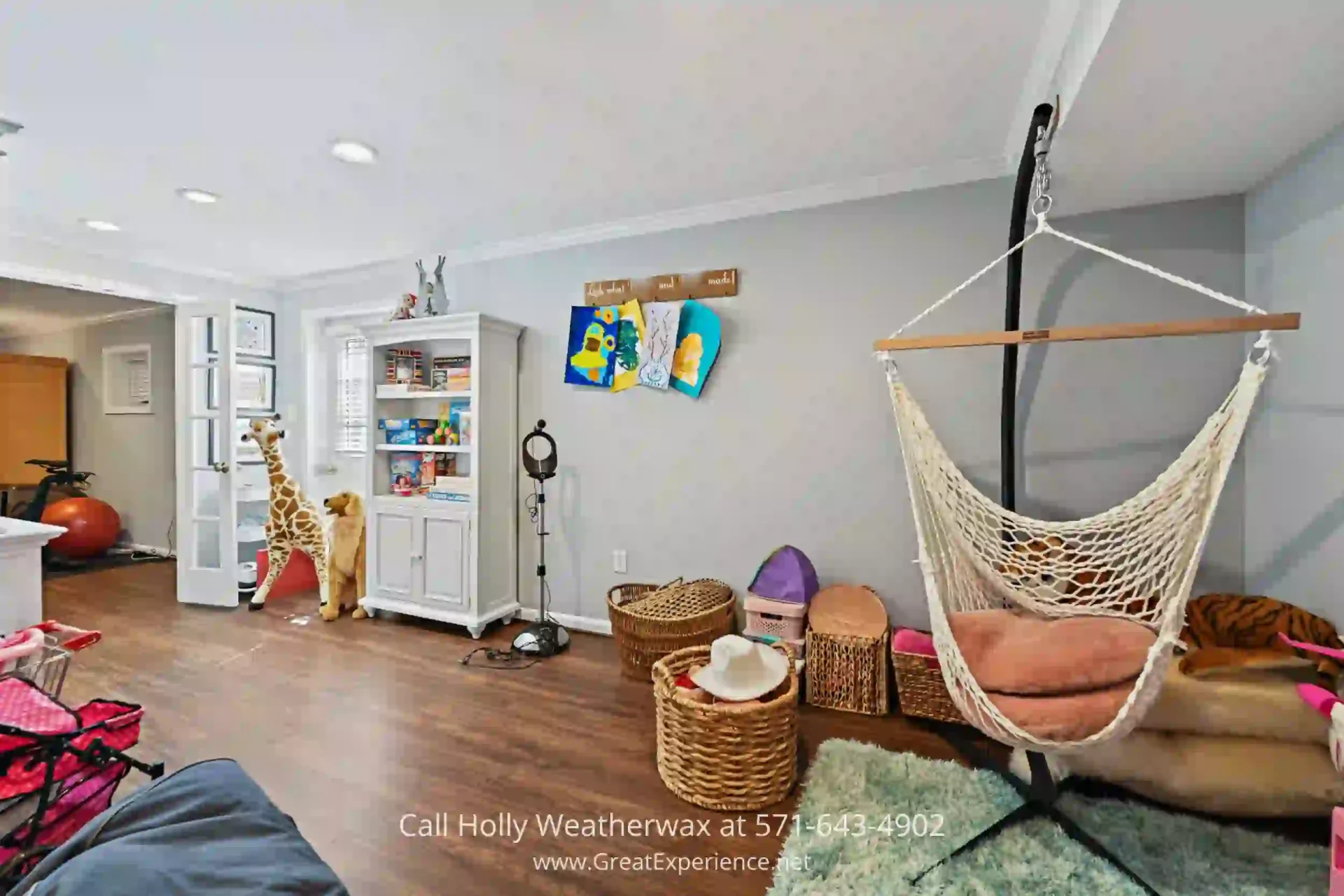 Homes for Sale in North Reston - Enjoy all types of indoor entertainment in the spacious lower level of this North Reston home. a family room with a hammock, chairs, and other items