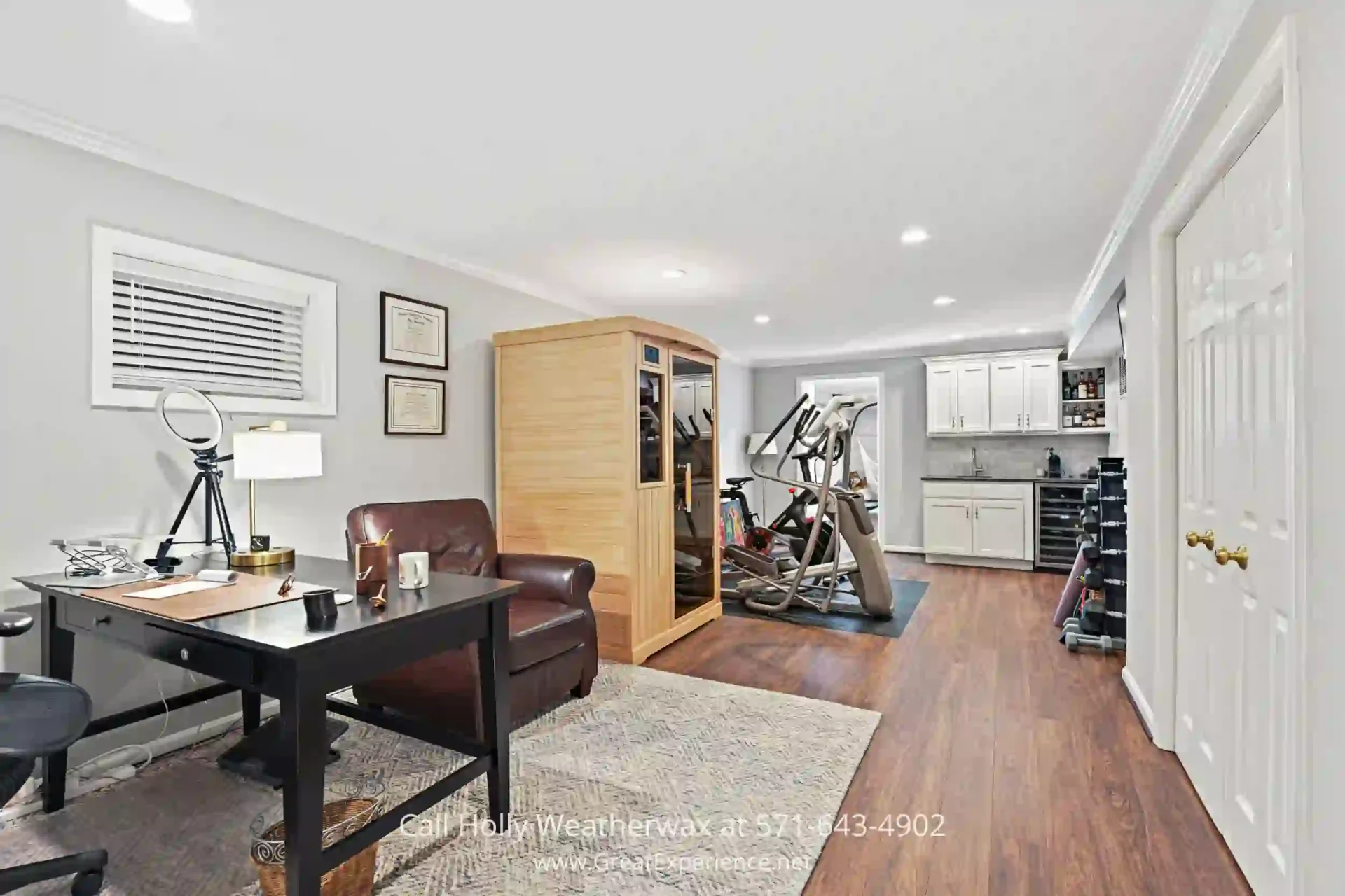 Homes for Sale in Reston VA - Get easy access to great amenities when you buy this home in Reston VA. a room with a desk, chair, and stationary bike