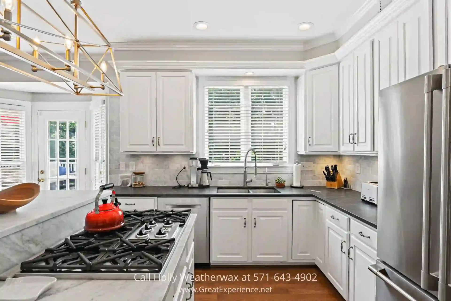 Three-Story Property in Reston VA - The kitchen of this Reston VA home is every cook’s delight. a kitchen with a stove top oven next to a refrigerator