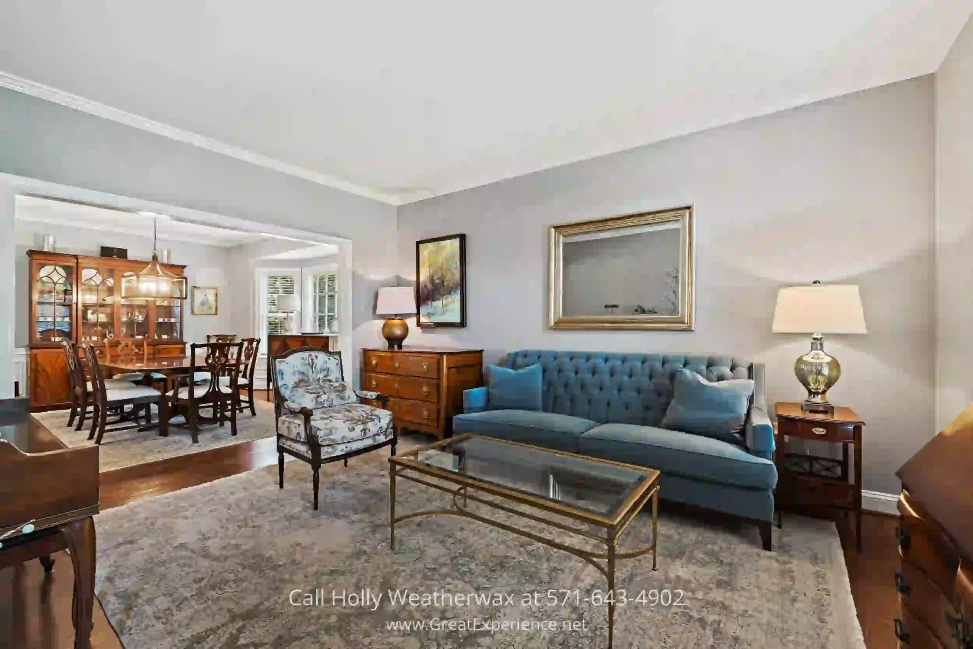 Home for Sale in North Reston VA - Entertain elegantly in the living room of this North Reston VA home. a living room filled with furniture and a painting on the wall