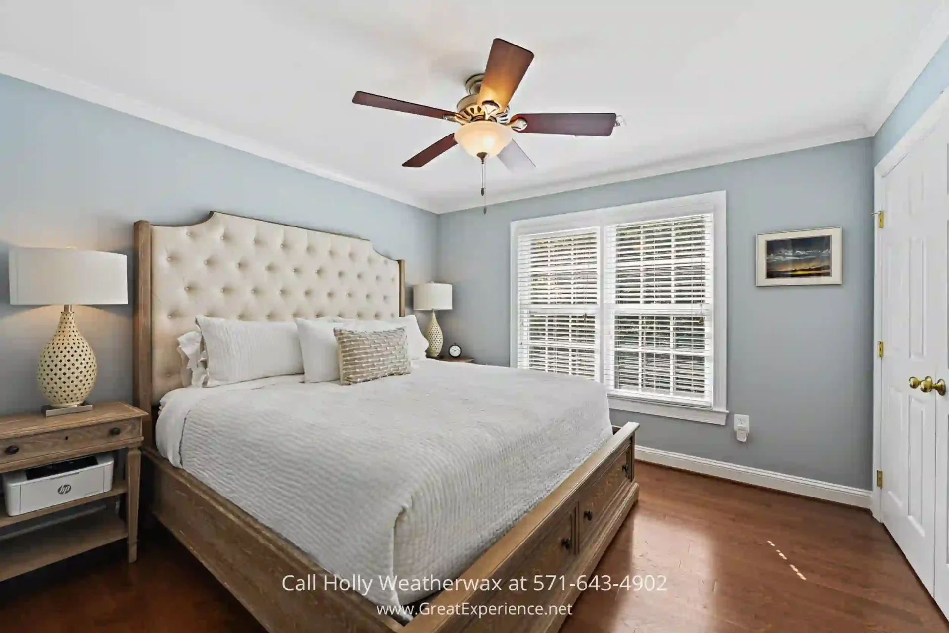 Four-Bedroom Home for Sale in Reston - All four bedrooms feature hardwood floors, crown molding and fans in Reston VA. a bedroom with a neatly made bed and a ceiling fan