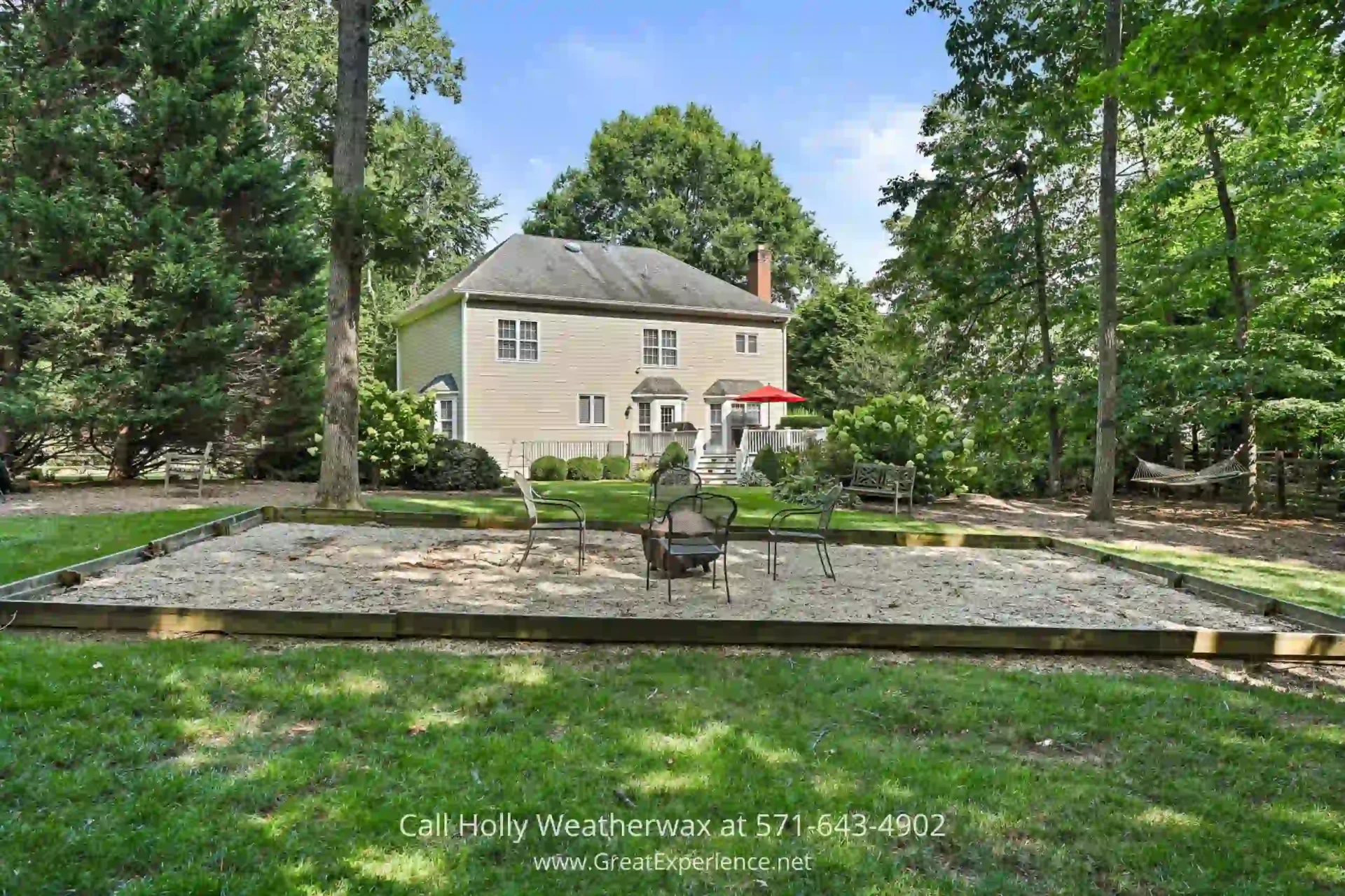 North Reston Home For Sale - A luxurious home in North Reston VA on more than ½ acre. a house in the middle of a yard with a table and chairs