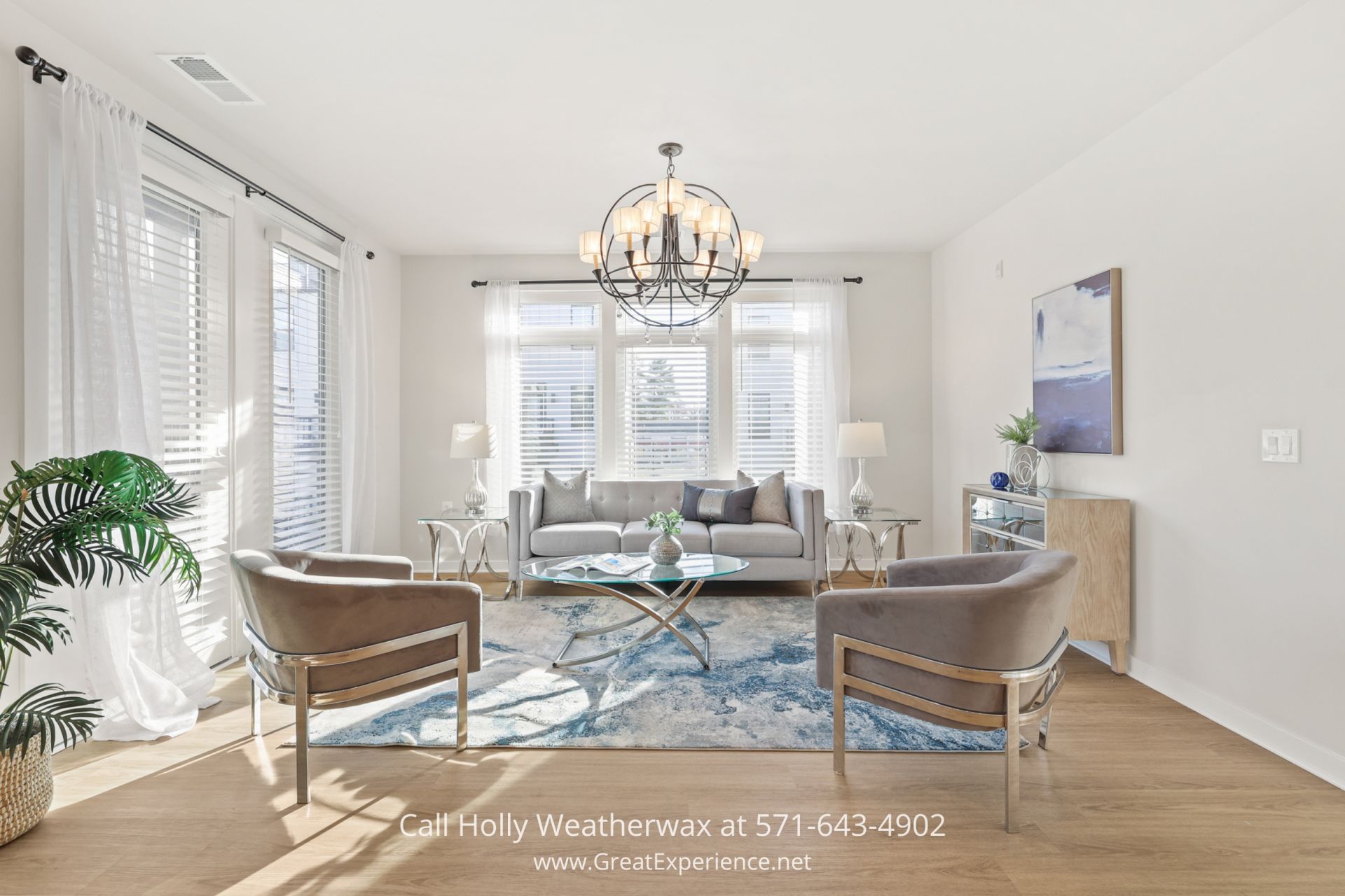 Homes for Sale in Reston VA - Open-concept Great Room of a Reston VA condo featuring large windows and contemporary design a living room filled with furniture and a chandelier