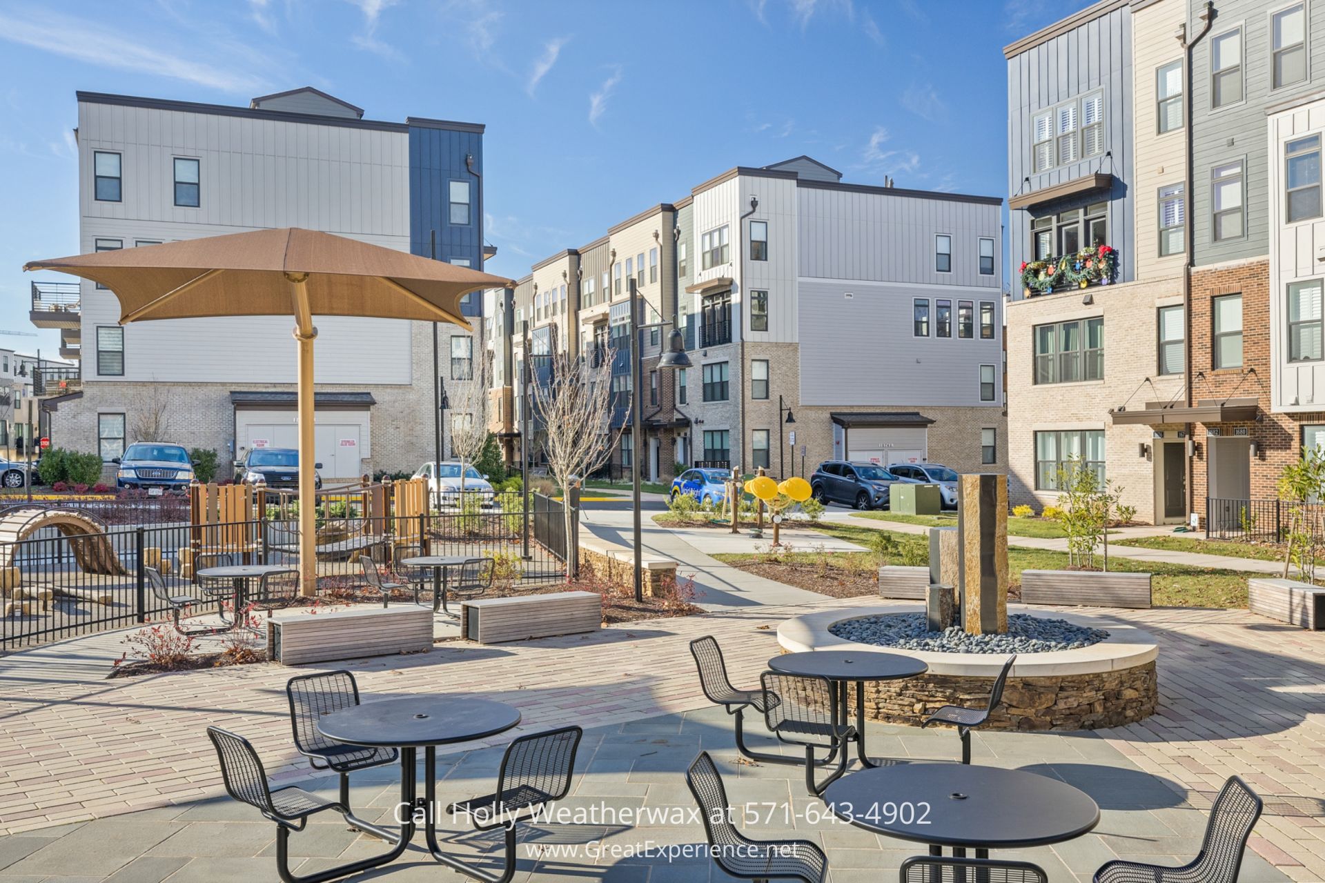 Condo in Reston VA - Reston VA Condo Living Area with Chic Custom Window treatments, near Reston Metro and Shopping Centers a courtyard with tables and chairs and an umbrella